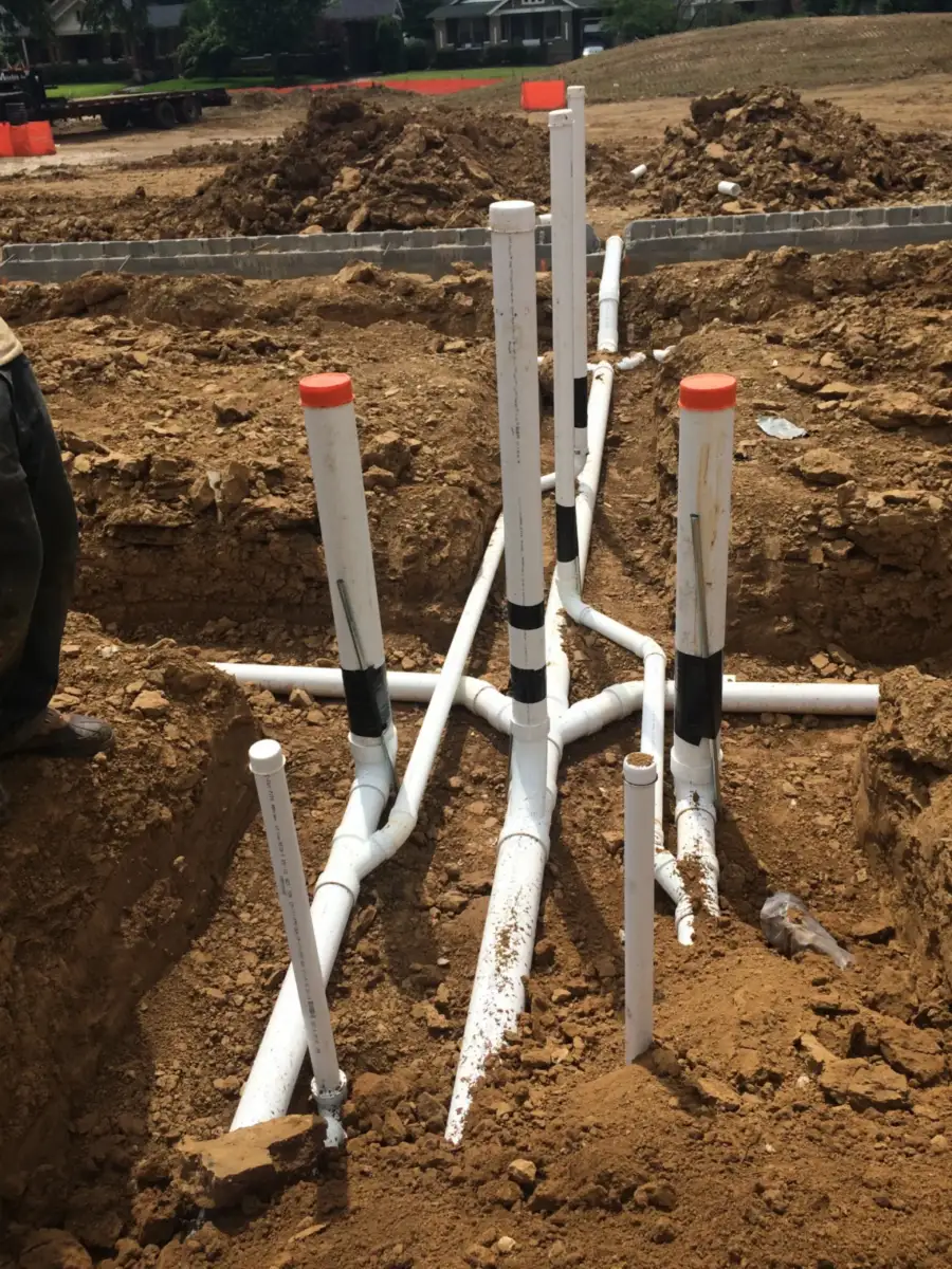 Underground PVC rough-in pipes before a slab pour